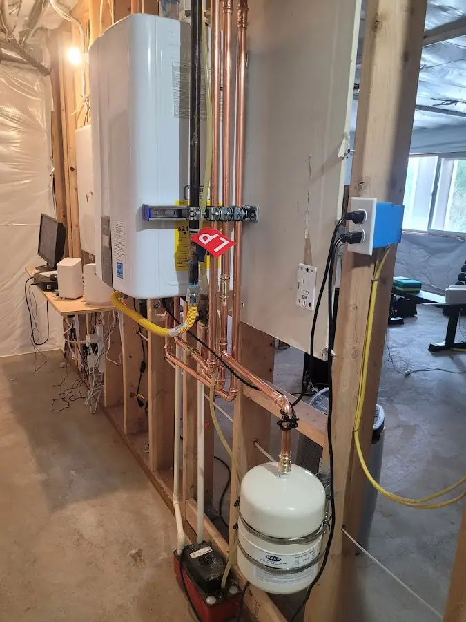 Licensed plumber repairing a kitchen sink in West Haven